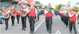  ??  ?? The Dannevirke Brass Band, with musicians from Napier, Wellington, Feilding, Palmerston North and Woodville, lead the parade down High St.