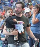  ?? GETTY IMAGES ?? Serena Williams’ husband, Alexis Ohanian, carries Alexis Olympia, who is holding Qai Qai.