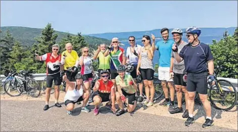  ?? CONTRIBUTE­D ?? Derek Watts, second from left, and fellow cyclists on top of Smokey on day four of the Velo Cape Breton-led Cabot Trail ride.