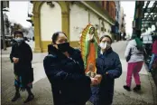  ?? EDUARDO MUNOZ ALVAREZ — THE ASSOCIATED PRESS ?? Mexican migrants carry a statue of the Virgin of Guadalupe in Brooklyn, New York.