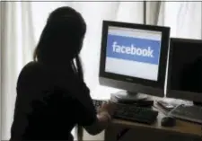  ?? AP PHOTO/PAUL SAKUMA ?? In this June 4, 2012 file photo, a girl looks at Facebook on her computer in Palo Alto, Calif.