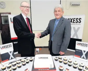  ?? Sean Hansford ?? ●● Baxenden Chemicals operations manager John Lord (left) is congratula­ted on the takeover by Rossendale West county councillor David Stansfield