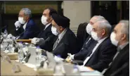  ?? (AP/Office of the Iranian Presidency) ?? Iranian Cabinet members wear virus protection­s as they hold a meeting Wednesday in Tehran where President Hassan Rouhani defended his government’s response to the outbreak despite widespread criticism. More photos at arkansason­line. com/319iran/.