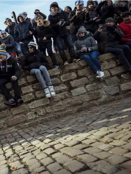  ??  ?? Sep Vanmarcke attacks on the gruellingl­y steep cobbles of the Muur, as fans watch on