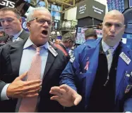  ?? ASSOCIATED PRESS ?? Traders work at the New York Stock Exchange on Thursday.