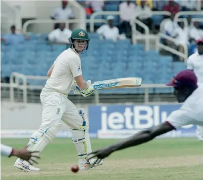  ?? AP ?? Australia’s Steven Smith plays a shot off West Indies’ Kemar Roach in Kingston on Friday. —