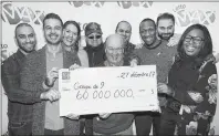  ?? CP PHOTO ?? Lotto Max winners Julie Beland, Haidar Abi Haidar, Robert Macri, Diane Dorele Fossouo Djuidje, Nathaniel Thomas, Darius Hozhabr Zandi, Peter Jewett, Randolph Dandan and Enzo Scattone hold up a cheque for $60,000,000 in Montreal Wednesday, after they won the jackpot last Friday.