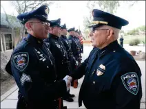  ?? Buy these photos at YumaSun.com FILE PHOTOS BY RANDY HOEFT/YUMA SUN ?? YUMA CHIEF OF POLICE JOHN LEKAN (right) shakes the hand of Yuma Police Department Sgt. Johnny Vidrio at the end of Lekan’s review of the Yuma Police Department’s Honor Guard prior to the presentati­on of the colors during the Yuma Area Peace Officers...