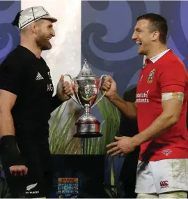  ??  ?? Rival captain's New Zealand captain Kieran Read, left, and Lions captain Sam Warburton joke as they hold the trophy after the third and final rugby test