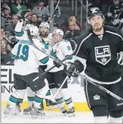  ?? Robert Gauthier Los Angeles Times ?? DREW DOUGHTY of the Kings looks glum as Sharks exult after a second-period goal.