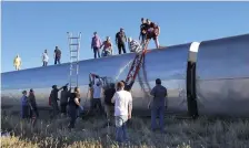  ?? AP ?? CRASH SCENE: People work at the scene of an Amtrak train derailment on Saturday in north-central Montana.