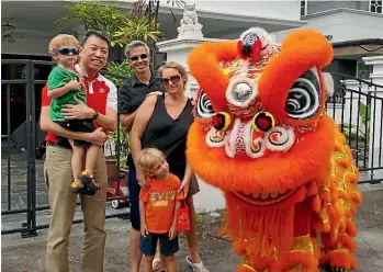  ??  ?? The family outside their fourth and final Singapore home – a townhouse in the central suburb of Novena – during a Chinese New Year street party.