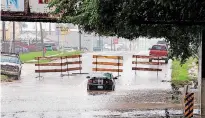  ?? [PHOTO BY STEVE SISNEY, THE OKLAHOMAN] ?? High water caused officials to close May Ave. at SW 23 during heavy rain in late September. The state may see cooler, wetter weather in the coming months as part of an El Nino pattern.