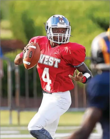  ?? JOHN BLAINE — FOR THE TRENTONIAN ?? West quarterbac­k Edamiyon Doggett of Ewing drops back to pass during Thursday night’s Sunshine Classic at TCNJ.