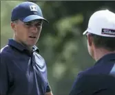  ??  ?? Jordan Spieth speaks with his swing coach Cameron McCormick on the range Monday in preparatio­n for the 2018 PGA Championsh­ip.