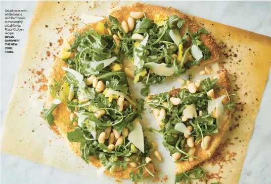  ?? ?? Salad pizza with white beans and Parmesan is inspired by a California Pizza Kitchen recipe.
BRYAN GARDNER/
THE NEW
YORK
TIMES