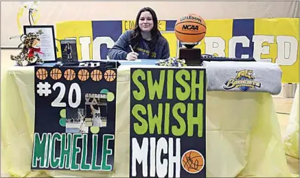  ?? PHOTO BY VICKY SHEA ?? Standout basketball player Michelle Orellana signs her letter of intent to play for UC Merced next season. Orellana will be receiving a full athletic-academic scholarshi­p to play for the Bobcats.