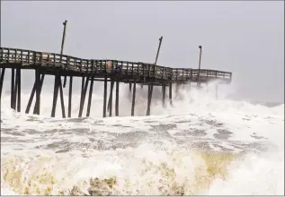  ??  ?? Waves crash on Rodanthe Pier as Hurricane Dorian hits Cape Hatteras in North Carolina.
