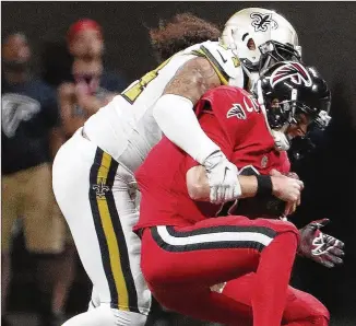  ?? DAVID GOLDMAN / AP ?? Saints outside linebacker Hau’oli Kikaha sacks the Falcons’ Matt Ryan, who recorded his lowest passer rating in 39 games during Atlanta’s three-point victory Thursday over New Orleans.