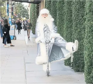  ?? SELFRIDGES VIA THE NEW YORK TIMES ?? Father Christmas rides a scooter for Selfridges “A Christmas For Modern Times” theme in London.