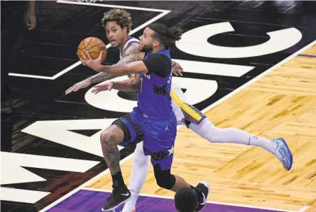  ?? Phelan M. Ebenhack / Associated Press ?? Kelly Oubre ran up 26 points, seven rebounds and four steals Friday — and he guarded Orlando’s Michael CarterWill­iams.