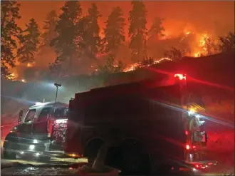  ?? West Kelowna Fire Rescue ?? A crew with West Kelowna Fire Rescue assists firefighte­rs from Peachland and the BC Wildfire Service at the Mount Eneas fire near Brent Road on Thursday night. The fire burning four kilometres south of Peachland was estimated at 1,000 hectares in size on Friday.