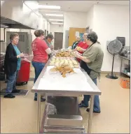  ?? COURTESY PHOTO ?? Staff with Farmington School District’s nutrition department prepare meals to be delivered to students last week. The governor closed schools March 16-23 and has now extended that through April 17. Farmington will continue to deliver meals to students after spring break.