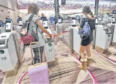  ??  ?? Passengers scan their passports at automated immigratio­n gates at the newly-opened Changi Internatio­nal Airport’s Terminal 4 in Singapore. The cutting edge terminal, which is half the size of Terminal 3 at 225,000 square meters, makes it Changi...