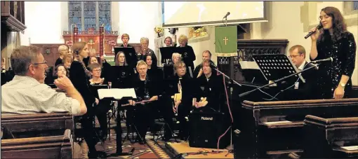  ??  ?? Kristyna Myles, right, and the Heart of England Recorder Orchestra - Hero - led a mass rendition of Abba’s Thank You for the Music at a tribute concert in memory of Elizabeth ‘Liz’ Hextall held in All Saints’ Church, Sapcote, on October 8 2017, watched...