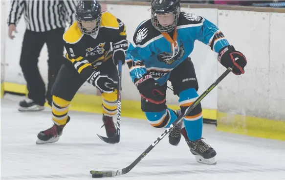  ??  ?? Kaleb Benney in action for the Grizzlys Ice Hockey Club. BELOW: Hunter Boland after winning his gold.