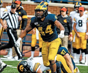  ?? TONY DING/AP ?? Michigan linebacker Cameron McGrone celebrates his sack of Iowa quarterbac­k Nate Stanley in the fourth quarter.