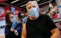  ?? Jay Laprete / Associated Press ?? Ohio State University clinic manager Paige Blankenshi­p gives the Johnson & Johnson vaccine to Osvaldo Campanella on Tuesday.