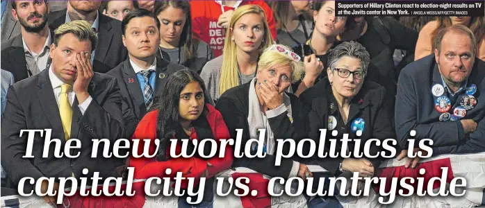  ?? | ANGELAWEIS­S/ AFP/ GETTY IMAGES ?? Supporters of Hillary Clinton react to election- night results on TV at the Javits center in New York.