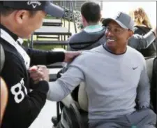  ?? REED SAXON — THE ASSOCIATED PRES ?? Tiger Woods greets a wellwisher after a news conference where he talked about his charitable works off the course and his return to competitiv­e golf in the Genesis Open at Riviera Country Club.