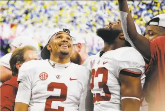  ?? Kevin C. Cox / Getty Images ?? Alabama’s Jalen Hurts (2), who lost his job as the starting quarterbac­k to Tua Tagovailoa in last season’t SEC title game, came in late Saturday and led two TD drives against Georgia.