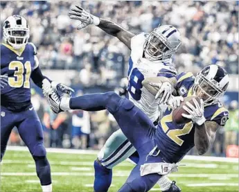  ?? Robert Gauthier Los Angeles Times ?? TRUMAINE JOHNSON nearly pulls down an intercepti­on against Cowboys receiver Dez Bryant on Sunday. The Rams forced two turnovers and didn’t commit one in a second straight road win.