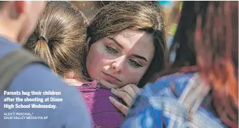  ?? ALEX T. PASCHAL/ SAUK VALLEY MEDIA VIA AP ?? Parents hug their children after the shooting at Dixon High School Wednesday.