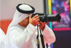  ?? Virendra Saklani/Gulf News ?? A visitor trying a Nikon camera model. Gitex Shopper will continue till October 6.