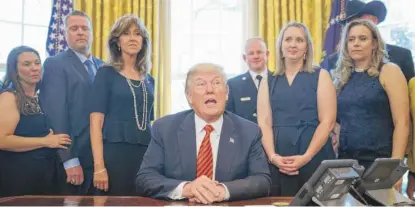  ?? CAROLYN KASTER/ AP ?? SOLEMN TRIBUTE: President Donald Trump meets with crew and passengers of Southwest Airlines Flight 1380, including pilot Tammie Jo Shults ( third from left), in the Oval Office on Tuesday. Trump hailed the “tremendous bravery” of the crew and...