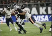  ?? TIM IRELAND — THE ASSOCIATED PRESS, FILE ?? Bears outside linebacker Khalil Mack tackles Raiders quarterbac­k Derek Carr during a game at Tottenham Hotspur Stadium in October of 2019 in London.