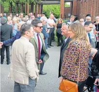  ??  ?? Poet Gary Robertson, left, was among the mourners who made their way into the funeral service at the crematoriu­m, top and right.