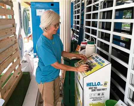  ??  ?? A resident placing old chargers into MCMC’s Mobile e-Waste Collection Box at a community recycling centre in Taman Tun Dr Ismail in Kuala Lumpur. — YIP YOKE TENG/The Star