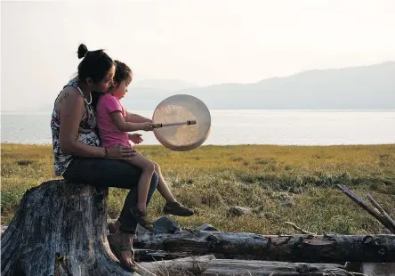  ?? SUPPLIED ?? A woman and her daughter from the Haisla First Nation spend time along the Douglas Channel in Kitamaat Village. The Haisla are one of the 25 Indigenous groups that signed agreements with LNG Canada and Coastal GasLink.