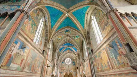  ?? DOMINIC ARIZONA BONUCCELLI ?? Assisi’s Basilica of St. Francis, colorfully frescoed by the Florentine artist Giotto, inspires tourists and pilgrims today.