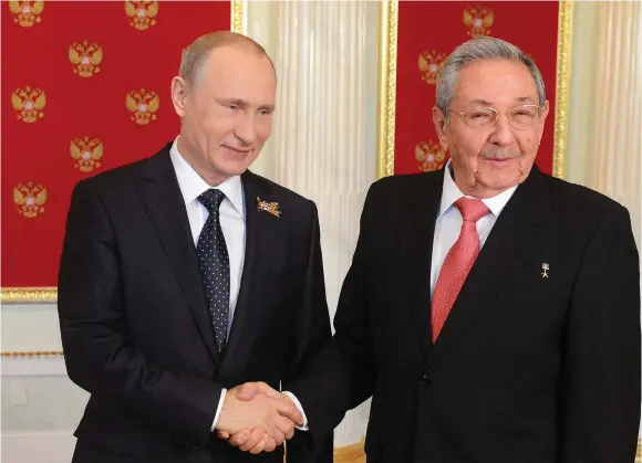  ?? (Reuters) ?? RUSSIAN PRESIDENT Vladimir Putin shakes hands with Cuban President Raul Castro during Putin’s welcome reception for foreign delegation­s’ heads and honorary guests in the Kremlin in Moscow in 2015.