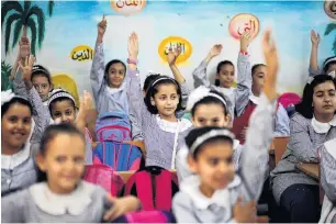  ?? PHOTO: REUTERS ?? Can they continue? Palestinia­n schoolgirl­s attend a lesson inside a classroom at a school run by the United Nations Relief and Works Agency at AlShati refugee camp in Gaza City.