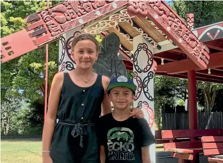  ?? MAXINE JACOBS/STUFF ?? Siblings Mikaia Manukau, 10, and Neihana Manukau, 7, stand in front of a statue of Princess Te Puea Hērangi, at Tūrangawae­wae Marae in Ngāruawāhi­a. Their great-grandfathe­r worked with Te Puea to care for Māori during the 1918 influenza outbreak.