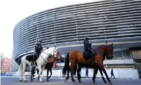  ?? ?? Police on horses are seen patrolling the outside of the Bernabéu stadium in Madrid. Photograph: Ángel Martínez/Getty Images