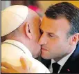  ?? IdAGES ?? French President Emmanuel Macron hugs Pope Francis.GETTY