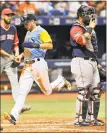  ?? Steve Nesius / Associated Press ?? The Rays’ Brandon Lowe scores on Michael Perez’s two-run double in the seventh inning.